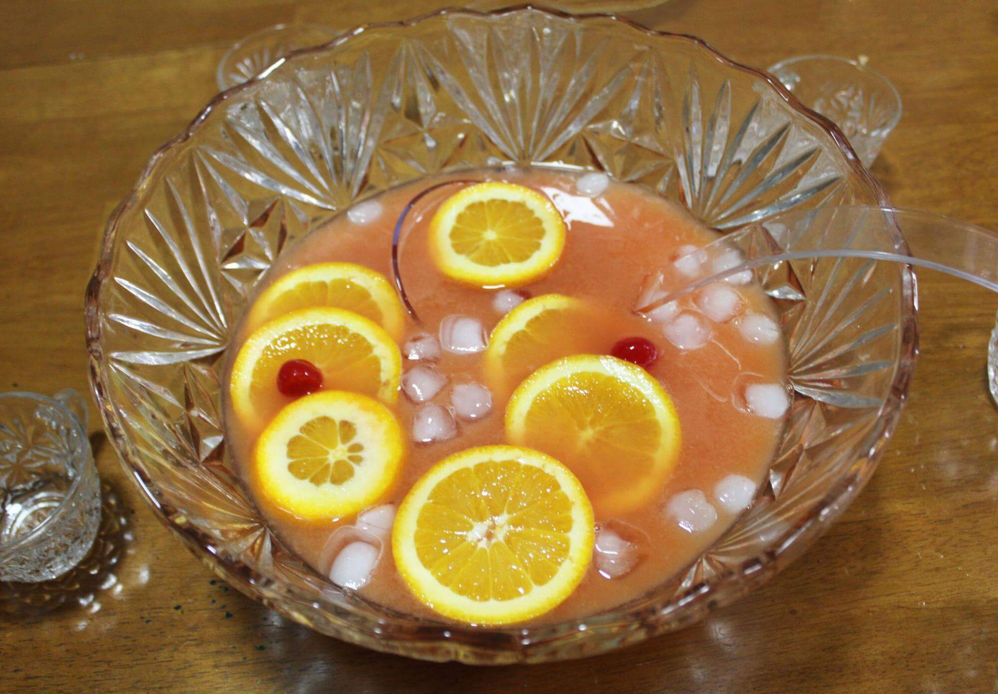 Punch bowl of Lucy's Prohibition Punch with ice, lemon slices and cherries.